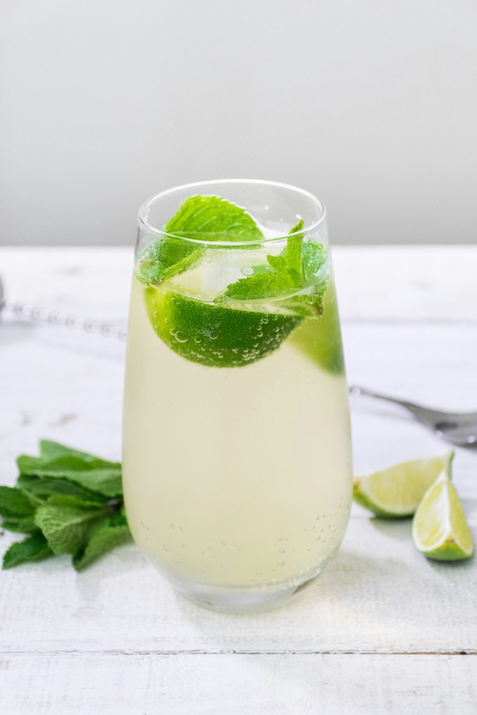 A light green drink with mint leaves and lime slices