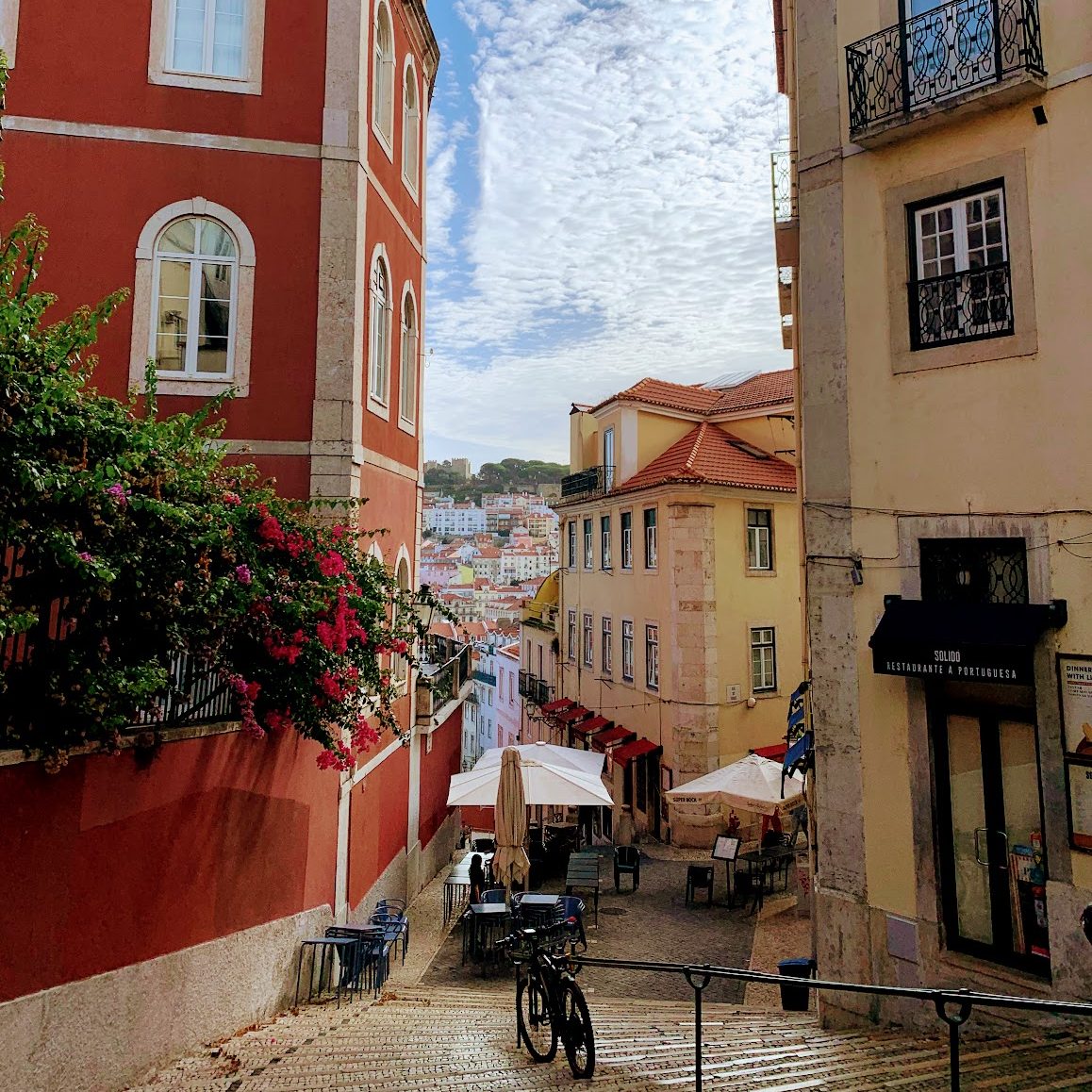 A steep pedestrian street in Lisbon with a stairs 