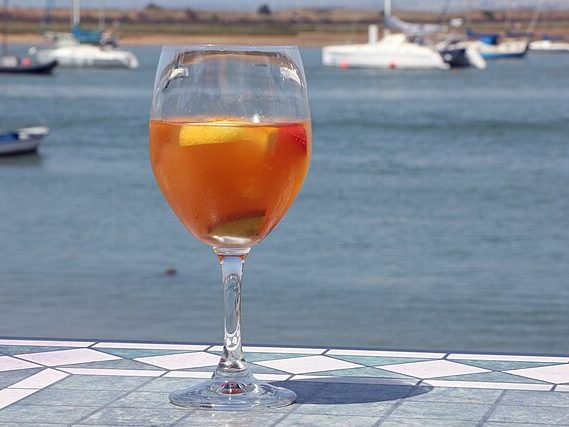 White Sangria, a Spanish cocktail, on a table next to the ocean