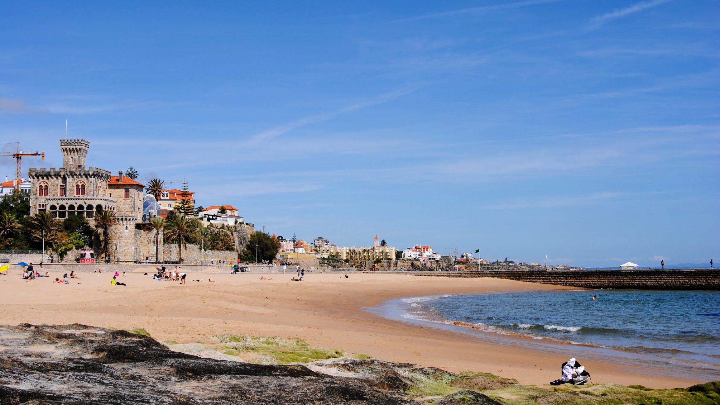 A beach in Portugal with a fortress in the background